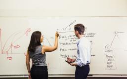 Two students at whiteboard