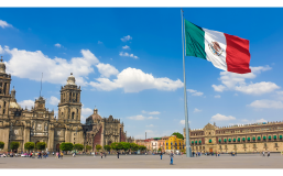 Mexico City's Zocalo with a Mexican flag in front of Mexico City Metropolitan Cathedral