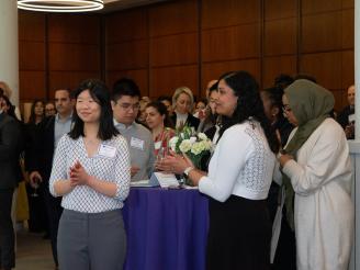 Reception attendees listening to speakers at the event