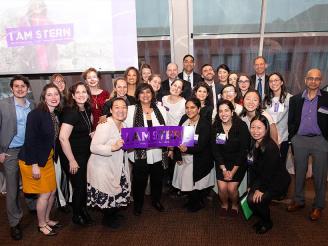 Dean Menon and Stern Undergraduate College Team pose with I am Stern sign