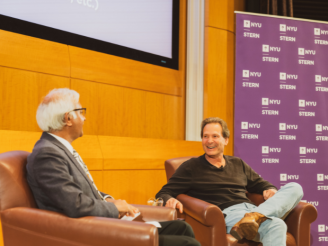 Dan Schulman smiles as he speaks to Dean Sundaram