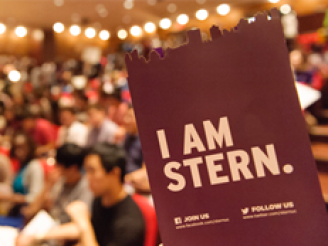 I am Stern logo in front of incoming class of students