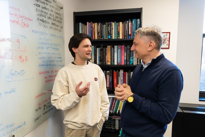 James Collett (BS ’24) talks with his advisor and economics professor, Gian Luca Clementi 