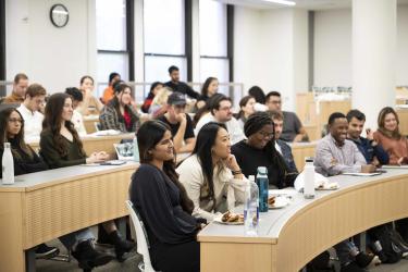 Students sit and listen to Liza Landsman speaking