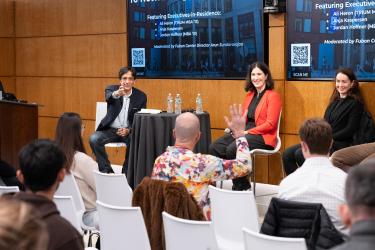 An attendee raises his hand to ask a question at the panel